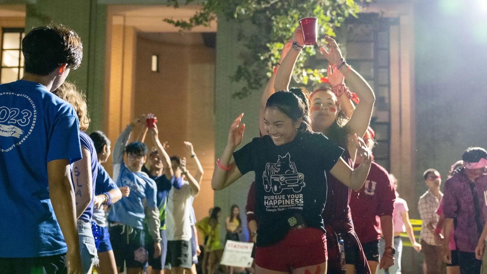 Students dancing outside at night during Carnegie Cup